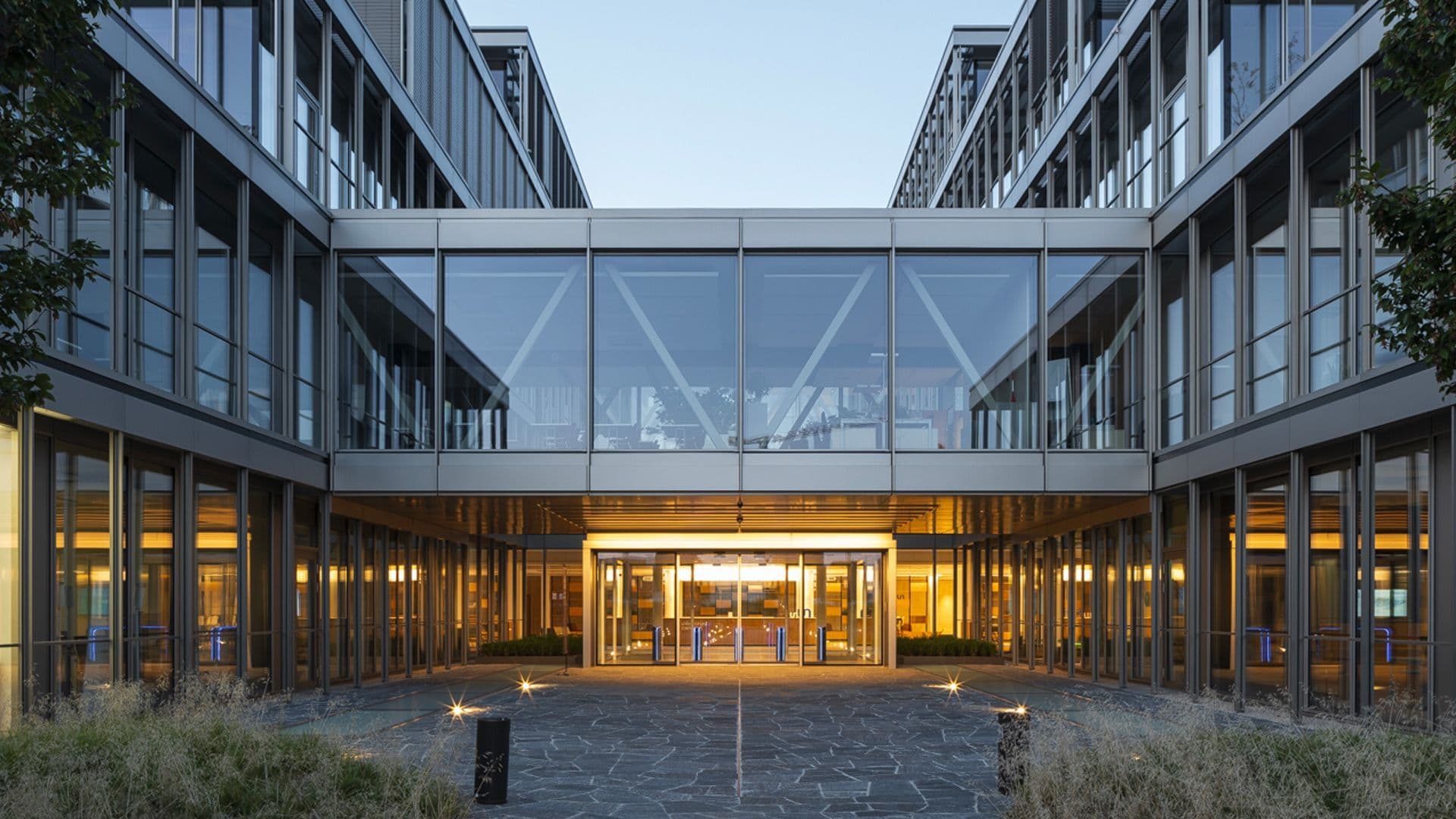 Modern glass entrance of Unlimitrust Campus innovation center in Prilly Switzerland where TofuPilot offices are located