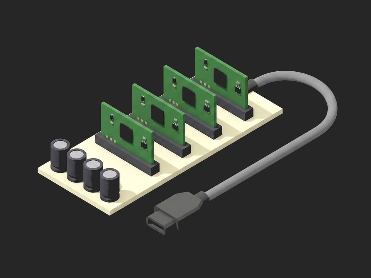 Burn-in load board close-up: four boards upright in edge-card sockets on the cream carrier, the bulk capacitors along the edge and the power cable leaving one end.